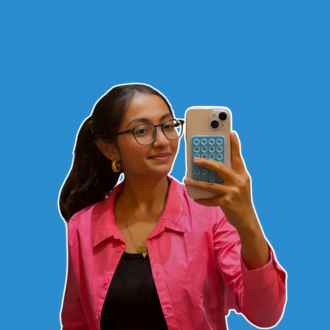 Content creator Heer showcasing the Squircle Sky Blue Stickypod, a versatile mobile suction phone accessory, similar to Octobuddy, that sticks to smooth surfaces to enhance hands-free content creation and productivity.