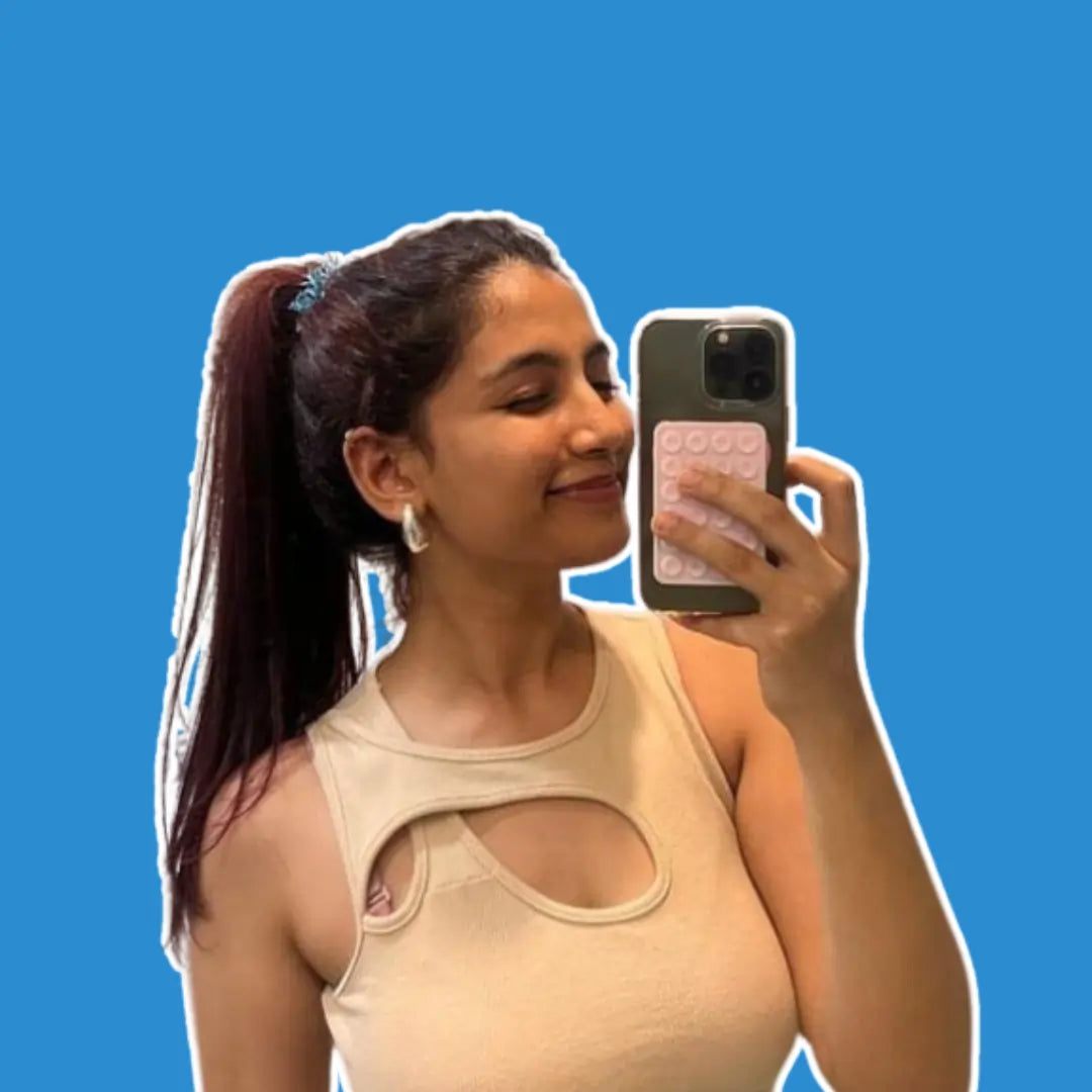 Content creators Nisman Parpia showcasing the Squircle Baby Pink Stickypod, a versatile mobile suction phone accessory, similar to Octobuddy, designed to stick to smooth surfaces for hands-free content creation and enhanced productivity.