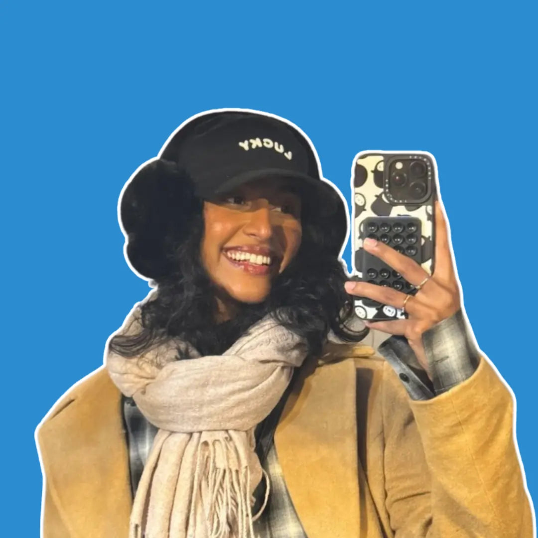 Rida Tharana demonstrating the Squircle Stickypod Wallet attached to her phone, highlighting its practicality for hands-free content creation with mobile suction technology, similar to Octobuddy.