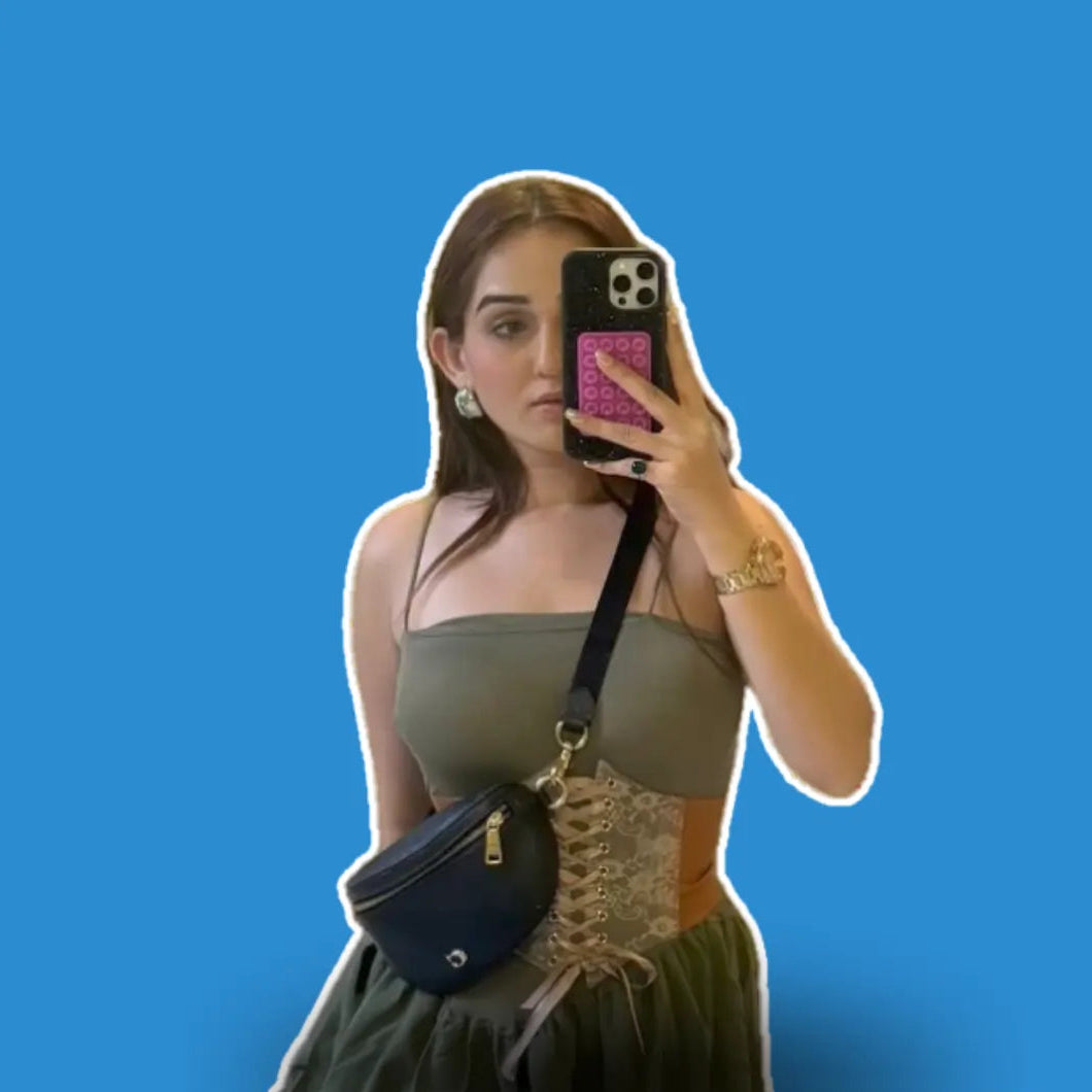 Woman taking a mirror selfie against a blue background